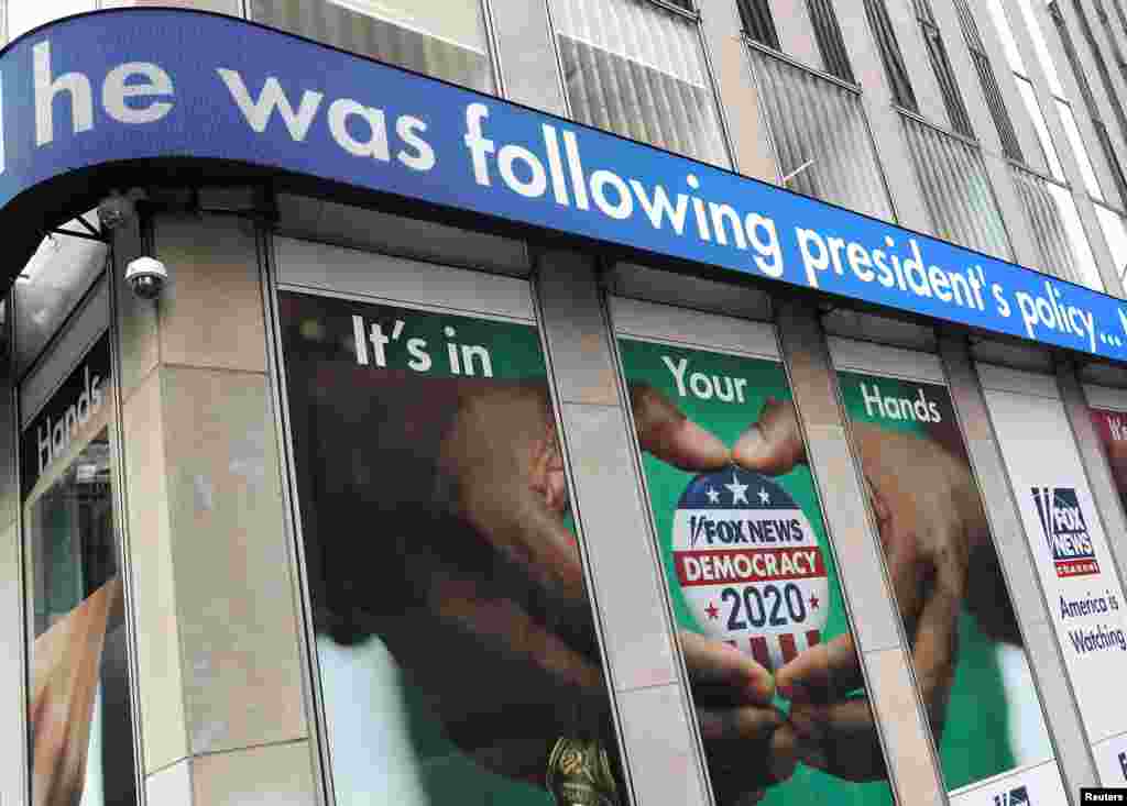 Headlines from the testimony of U.S. Ambassador to the EU Gordon Sondland to a House Intelligence Committee hearing as part of the impeachment inquiry into President Donald Trump are seen on a news display outside Fox News headquarters in New York.