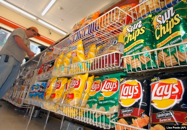 FILE - A customer makes a purchase at a convenience store in Boston in this July 12, 2005 file photo. (AP Photo/Lisa Poole, file)