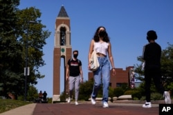 FILE - Masked students walk through the campus of Ball State University in Muncie, Ind., Sept. 10, 2020. …