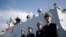 FILE - In this Dec. 7, 2016, photo, Chinese Navy officials stand in front of the ship Daqing, in San Diego.