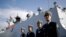 FILE - In this Dec. 7, 2016, photo, Chinese Navy officials stand in front of the ship Daqing, in San Diego. For the second year in a row, China has said it would increase its defense spending by a single-digit percentage.