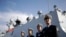 FILE - Chinese Navy officials stand in front of the ship Daqing.