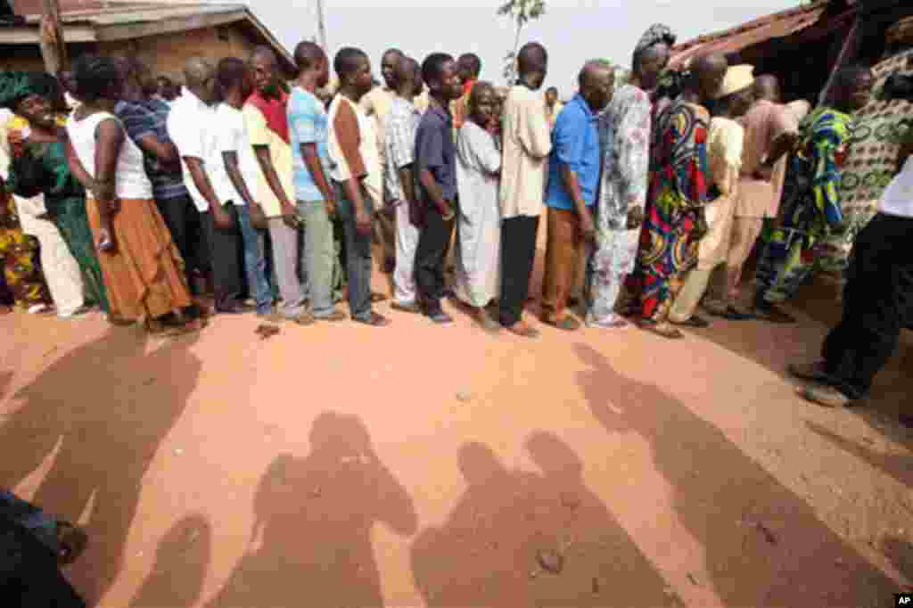 People wait to be registered at a polling station at Oyeleye in Ibadan, Nigeria, Saturday, April 9, 2011