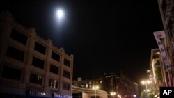 A police helicopter hovers over downtown Los Angeles as officers close in on a group of protesters, May 31, 2020.