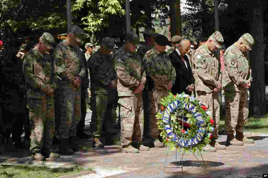 Jeneral John F. Campbell, kòmandan nan fòs entènasyonal la nan Afganistan, (2èm adwat), pran pozisyon salitasyon pandan yon seremoni pou komemore Memorial Day la nan katye jeneral &#39;Resolute Support&#39; nan Kaboul, 25 me 2015.