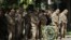 General John F. Campbell, commander of international forces in Afghanistan, second right, gives respect during a ceremony marking Memorial Day at the Resolute Support main headquarters in Kabul, Afghanistan, Monday, May 25, 2015.