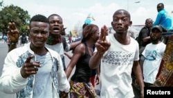 Congolese opposition activists gesture during a march to press President Joseph Kabila to step down in the Democratic Republic of Congo's capital Kinshasa, September 19, 2016.