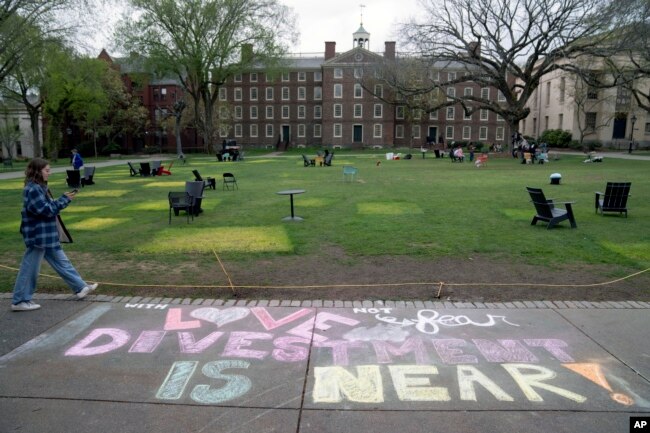 A message in chalk decorates a sidewalk after an encampment protesting the Israel-Hamas war was taken down at Brown University, Tuesday, April 30, 2024, in Providence, R.I. (AP Photo/David Goldman)