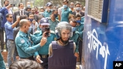 Mozammel Hossain, wearing bullet proof jacket and helmet, one among those convicted in the 2015 killing of Bangladeshi-American blogger Avijit Roy, is brought to be produced before the Anti-Terrorism Special Tribunal in Dhaka, Feb.16, 2021.