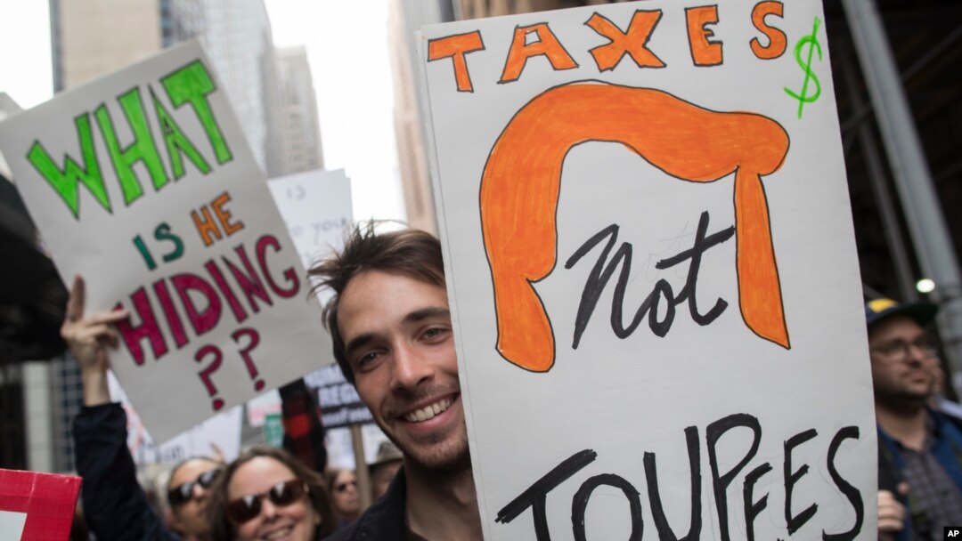 Demonstrators participate in a march and rally to demand President Donald Trump release his tax returns in New York, April 15, 2017.