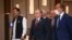 Pakistan's Prime Minister Imran Khan, left, Uzbekistan's President Shavkat Mirziyoyev, center, and Afghanistan's President Ashraf Ghani, behind Mirziyoyev, walk to attend a Central-South Asia trade summit in Tashkent, Uzbekistan, July 16, 2021.