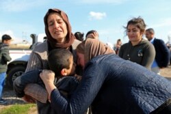 FILE - Relatives hug a Yazidi survivor following the boy's release from Islamic State militants in Syria, in Duhok, Iraq, March 2, 2019.