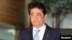 FILE - Japan's Prime Minister Shinzo Abe arrives at his official residence in Tokyo, Japan, in this photo taken by Kyodo, May 14, 2017, after South Korea's military said that North Korean had fired an unidentified projectile from a region near its west coast.