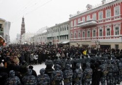 Law enforcement officers stand in front of participants during a rally in support of jailed Russian opposition leader Alexei Navalny in Kazan, Russia, Jan. 23, 2021.