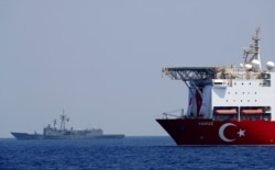 FILE - A Turkish drilling vessel is escorted by Turkish Navy frigate TCG Gemlik in the eastern Mediterranean Sea off Cyprus, Aug. 6, 2019.