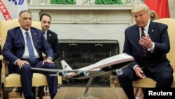 U.S. President Donald Trump speaks with Iraq's Prime Minister Mustafa al-Kadhimi, as a translator listens in the Oval Office at the White House in Washington, Aug. 20, 2020.