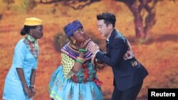 Chinese actor Lou Naiming, center, performs a skit on a Lunar New Year gala in Beijing, China, Feb. 15, 2018.