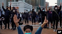 Protesters raise five demands gestures during a rally in Hong Kong, Jan. 12, 2020. 