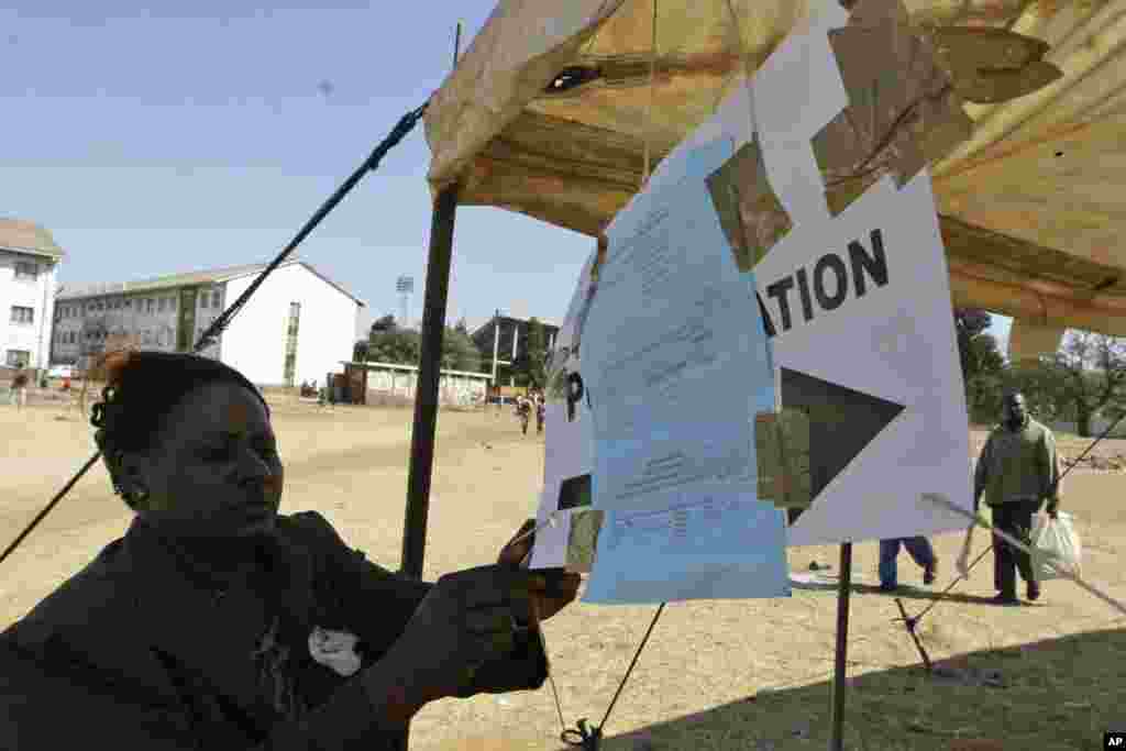 A polling official puts up results of the presidential runoff election outside a polling station in Harare, Saturday, June, 28, 2008. Many Zimbabweans deliberately defaced their ballots in a discredited presidential runoff with President Robert Mugabe as the sole candidate, and voted only out of fear, the head of a foreign observer mission said.