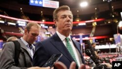 FILE - Paul Manafort talks to reporters on the floor of the Republican National Convention at Quicken Loans Arena in Cleveland.