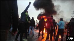 FILE - Anti-government protesters take to the streets in Iran, November 2019.