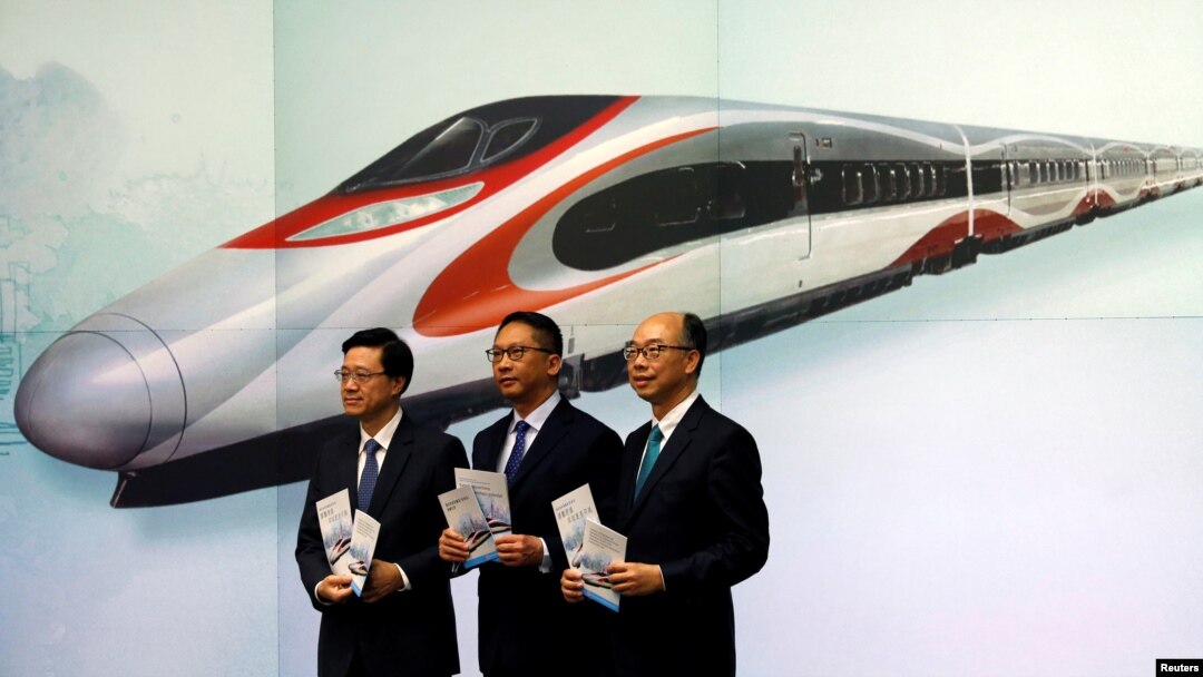 Secretary for Security John Lee, from left, Secretary for Justice Rimsky Yuen and Secretary for Transport & Housing Frank Chan pose at a news conference on arrangements at West Kowloon Terminus for the Guangzhou-Shenzhen-Hong Kong Express Rail Link in Kong, July 25, 2017.