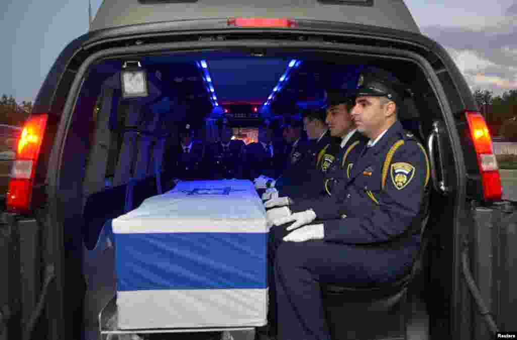 The coffin of former Israeli President Shimon Peres is seen inside a hearse as it is transferred from Tzrifim army base to Jerusalem, near Ramle.