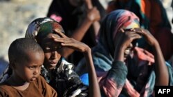 Somali women and children wait for relief supplies from the UN High Commission for Refugees, in Galkacyo, Somaliland, December 2010. (file photo)