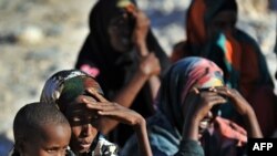 Somali women and children wait for relief supplies from the UN High Commission for Refugees, in Galkacyo, Somaliland, December 2010. (file photo)