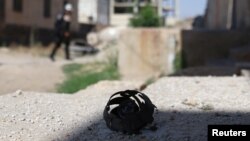 The remains of a cluster bomblet is pictured in the rebel-held town of Dael in Deraa Governorate, Syria, June 27, 2017. 