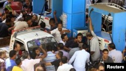 People argue at a petrol station during a fuel shortage in Cairo, June 26, 2013.