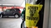 FILE - An "out of service" bag covers a gas pump as cars line up at a Circle K gas station near uptown Charlotte, N.C., May 11, 2021, following a ransomware attack that shut down the Colonial Pipeline, a major East Coast gasoline provider. 