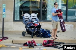 A community member collects his belongings the day after a mass shooting at a Fourth of July parade in the wealthy Chicago suburb of Highland Park, Illinois, U.S. July 5, 2022. (REUTERS/Cheney Orr)