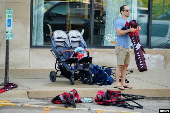 A community member collects his belongings the day after a mass shooting at a Fourth of July parade in the wealthy Chicago suburb of Highland Park, Illinois, U.S. July 5, 2022. (REUTERS/Cheney Orr)