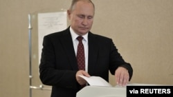 FILE - Russian President Vladimir Putin casts his ballot at a polling station during the Moscow city parliament election in Moscow, Russia, Sept. 8, 2019. (Sputnik/Alexei Nikolsky/Kremlin via Reuters)