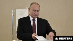 FILE - Russian President Vladimir Putin casts his ballot at a polling station during the Moscow city parliament election in Moscow, Russia, Sept. 8, 2019. (Sputnik/Alexei Nikolsky/Kremlin via Reuters)