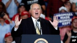 FILE - Radio personality Rush Limbaugh introduces President Donald Trump at the start of a campaign rally in Cape Girardeau, Mo., Nov. 5, 2018.