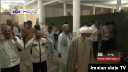 Iranian men worship without face masks at a reopened mosque in Roudbar, Kerman province in this screen grab from a May 5, 2020 report on Iranian state TV. 