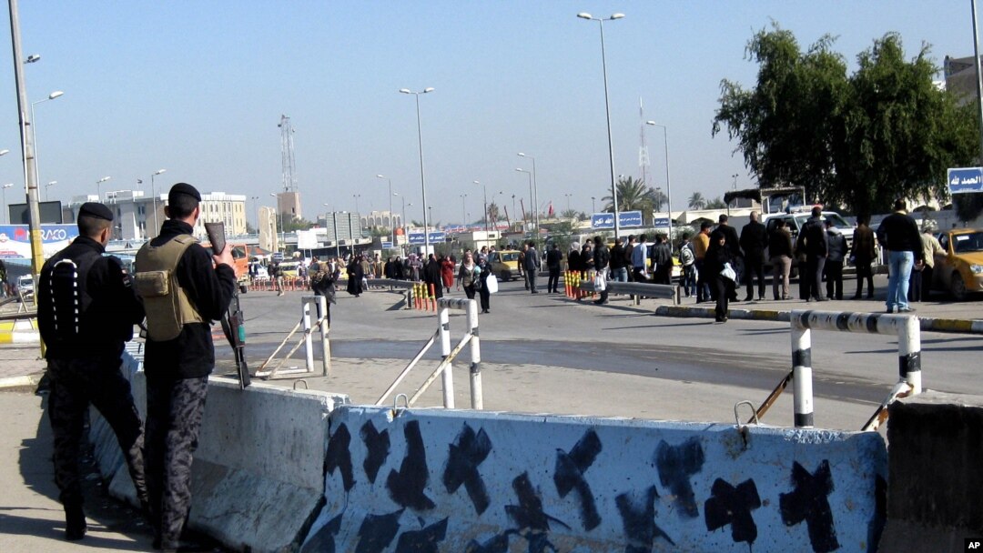 Pasukan penjaga keamanan Irak berjaga-jaga di tempat terjadinya serangan bom di Baghdad, Minggu 12 Januari 2014.