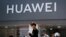 People walk past a Huawei retail store in Beijing, Sunday, June 30, 2019. Once again, Presidents Donald Trump and Xi Jinping have hit the reset button in trade talks between the world's two biggest economies, at least delaying an escalation in…
