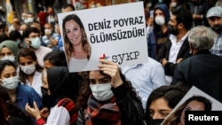 Demonstrators carry pictures of Deniz Poyraz, who was killed in an attack on a local office of the pro-Kurdish Peoples' Democratic Party (HDP), during a protest in Istanbul, Turkey, June 18, 2021. Banner reads "Deniz Poyraz is immortal."