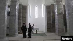 FILE - Ethnics Serbs attend an Orthodox Easter mass at Saint Sava church in Mitrovica, Kosovo, May 5, 2013.