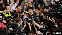 FILE - Pro-democracy activist Joshua Wong talks to reporters outside the Legislative Council during a demonstration in Hong Kong, June 17, 2019.