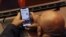 FILE - A Turkish lawmaker checks his mobile phone, in Ankara, Turkey, Jan. 2, 2020. 