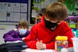 Students listen to a teacher during a lesson at Heath Mount school as schools reopen in England, amid the coronavirus pandemic, in Watton at Stone, Hertfordshire, Britain, March 8, 2021.