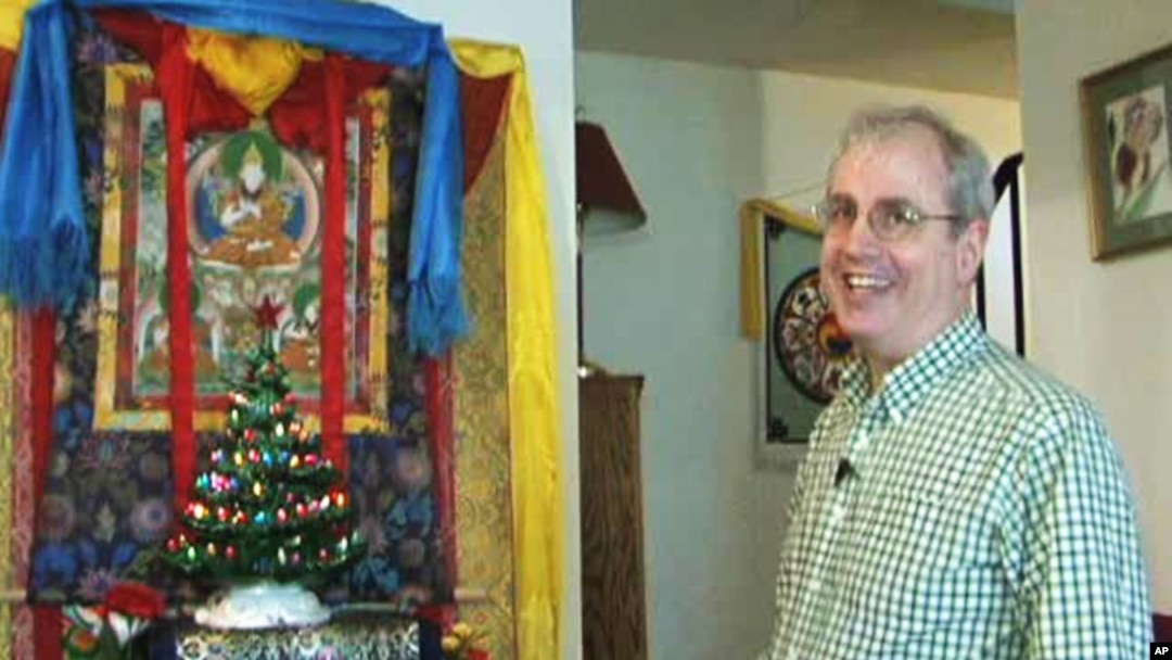 Wilson Hurley has put up a Christmas tree in his house in front of an image of Buddha