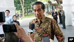 FILE - Indonesian President Joko Widodo talks to the media at Merdeka Palace in Jakarta, Oct. 21, 2014.