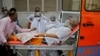 A patient wearing an oxygen mask is wheeled inside a COVID-19 hospital for treatment, amidst the spread of the coronavirus disease (COVID-19) in Ahmedabad, India, Apr. 26, 2021. 