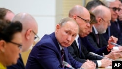 FILE - Russian President Vladimir Putin attends a meeting on drafting constitutional changes at the Novo-Ogaryovo residence outside Moscow, Russia, Jan. 16, 2020.