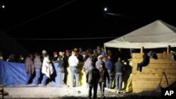 Rescue workers and miners stand at a mine where an explosion occurred in San Juan Sabinas, in the Mexican State of Coahuila, May 4, 2011